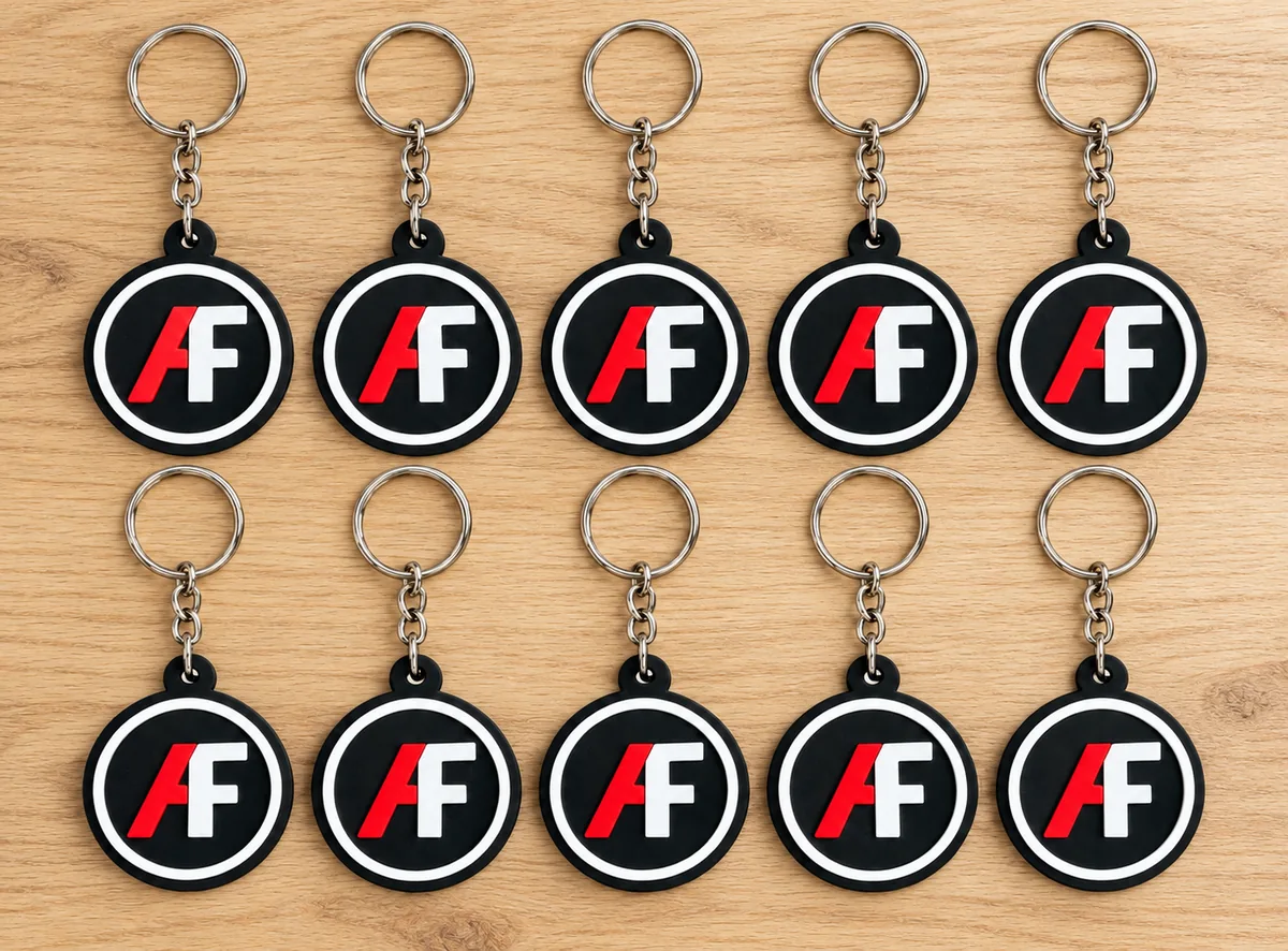 Ten multi-color 3D printed logo keychains